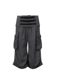 Victory jorts in grey from the Double Punch SS26 'Illusory Victory' collection. Flipped waistband design. Napoleon military jacket inspired double-breasted decorative buttons. Large side pockets. Baggy cargo shorts silhouette. Soft, comfortable 100% cotton fabric.